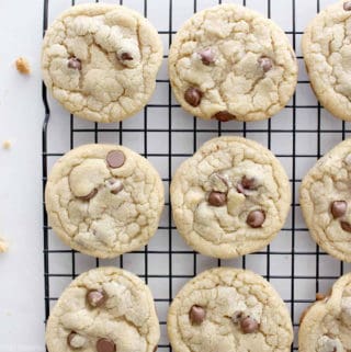 Freshly baked perfect chocolate chip cookies on a cooling rack.