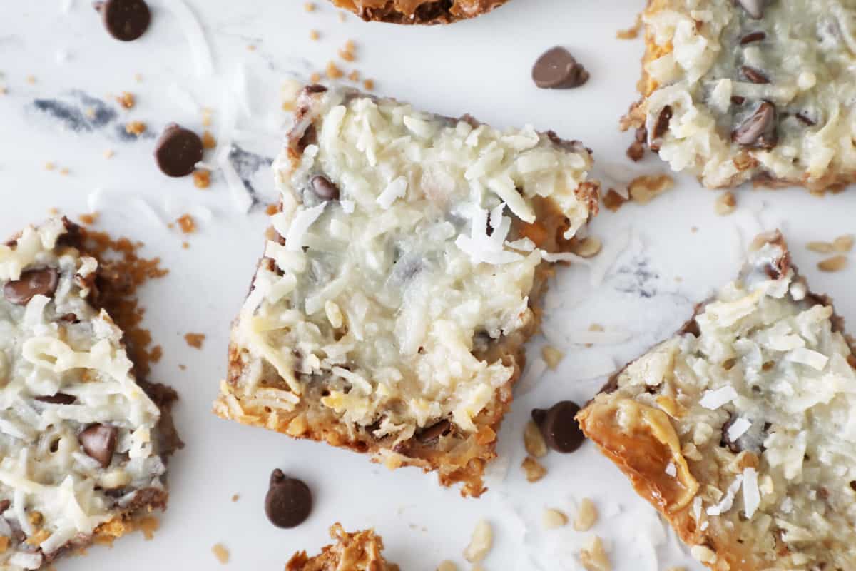four different magic cookie bars at angles on a countertop