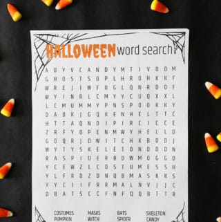 a halloween printable game on a dark background surrounded by candy corn