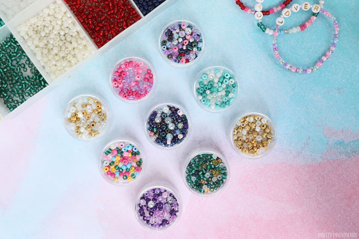 Beads organized by color in small pots. 