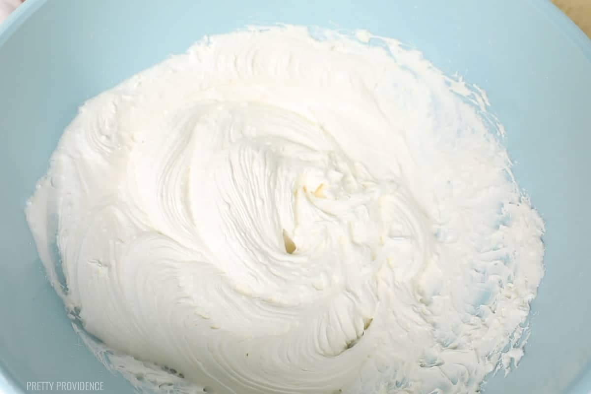 Frosting in a blue bowl.