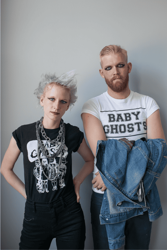 Woman and Man in Punk Rock t-shirts wearing heavy eyeliner and with spiked hair.